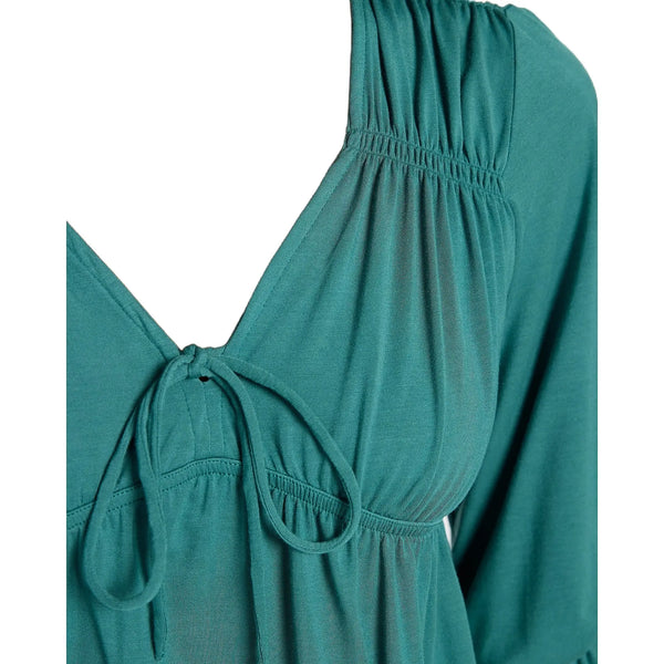 Close up view of the Flow V Neck Ruffle Blouse showing its lightweight fabric, delicate stitching, and ruffle details against a white background.