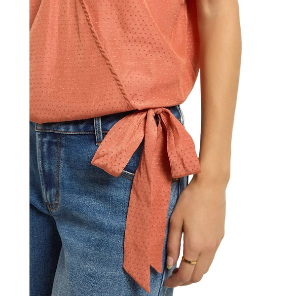 Close up of the Emily Surplice Short Sleeve Top showing the soft cotton fabric, cinched hem, and dolman sleeves in a vibrant hue.