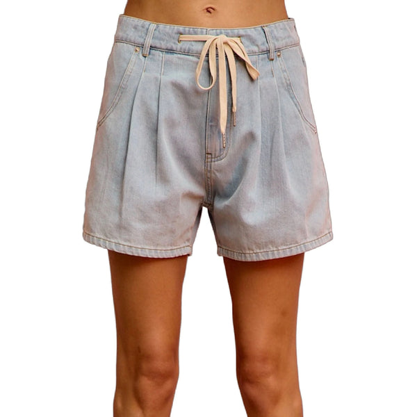 View of mid rise denim shorts in light blue, featuring a classic five pocket design and frayed hem