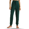 Green joggers with elastic waistband and cuffs, worn cropped torso view
