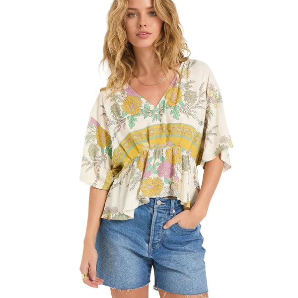 Close up view of the Emily Peplum Deep V Neck Blouse showing intricate stitching and lightweight fabric in a vibrant floral print against a white background.