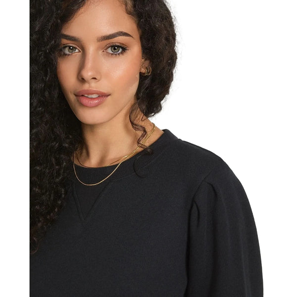 Close up view of the relaxed fit puff sleeve sweatshirt showing the soft French terry fabric, delicate stitching, and puff sleeve against a white background.