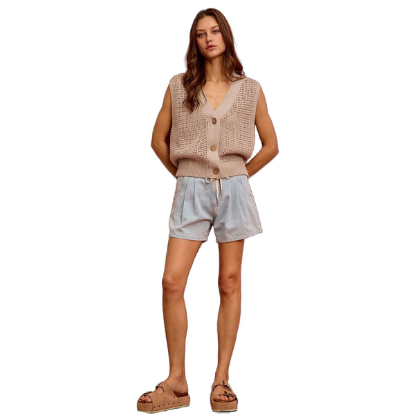 View of mid rise denim shorts in light blue, featuring frayed hem and five pocket design