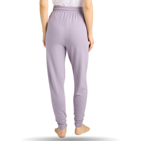 View of a person wearing light purple heathered joggers, standing barefoot on a white background