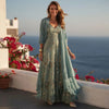 View of a two piece set featuring an elegant maxi dress in soft, flowing fabric with a deep green hue