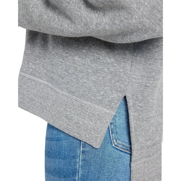 Close up view of the oversized step hem sweatshirt showing its soft cotton fabric, detailed stitching, and relaxed silhouette in a neutral color.