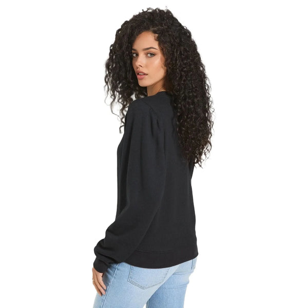 Back view of a model wearing a relaxed fit puff sleeve sweatshirt in a soft pastel color, showing the construction details and silhouette against a white background.