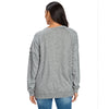 Back view of a model wearing a soft cotton oversized step hem sweatshirt in a muted gray color, showing the unique construction details and relaxed fit.