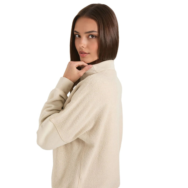 Close up of the vintage washed fleece pullover showing the soft texture, refined stitching, and Washed Camel, showing its and comfortable design.
