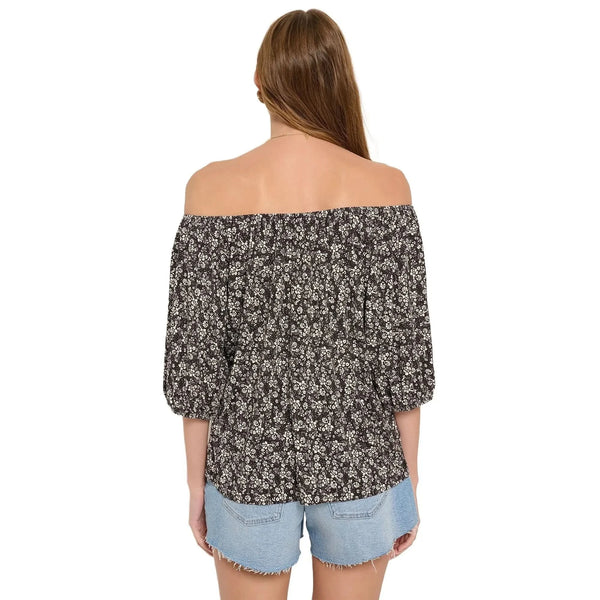 Back view of the Ava Off Shoulder Cotton Floral Top in a soft pastel color, showing its delicate construction and flowy silhouette against a white background.