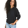 A model showcases a relaxed fit puff sleeve sweatshirt in Black, styled with high waisted jeans against a minimalistic white background.