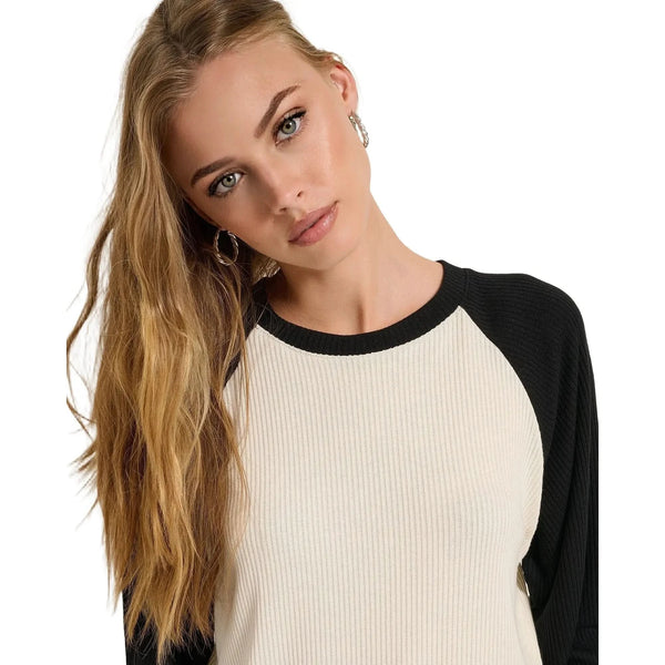 Close up view of the Emma Relaxed Raglan Long Sleeve Tee showing the soft rayon blend fabric and detailed stitching in a muted pastel color.