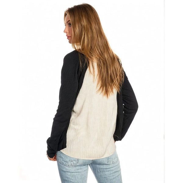Back view of a model wearing the Emma Relaxed Raglan Long Sleeve Tee in Cream Black, showing its relaxed fit and raglan sleeves against a white background.