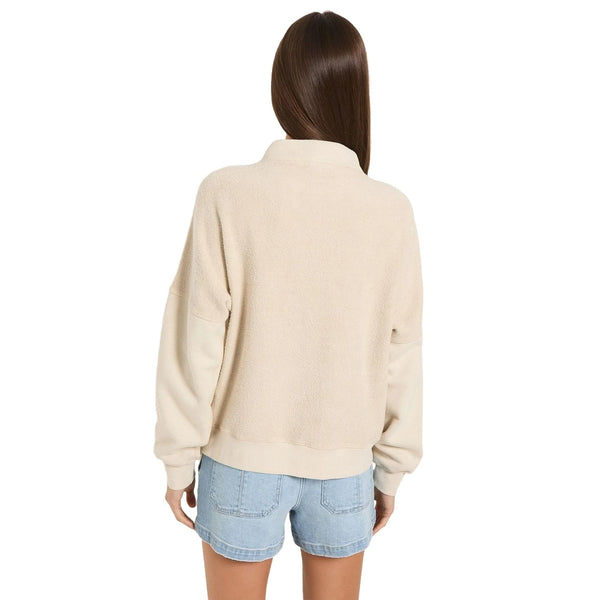 Close up view of the vintage washed fleece pullover showing its soft fabric texture, detailed stitching, and the unique quarter zip design.