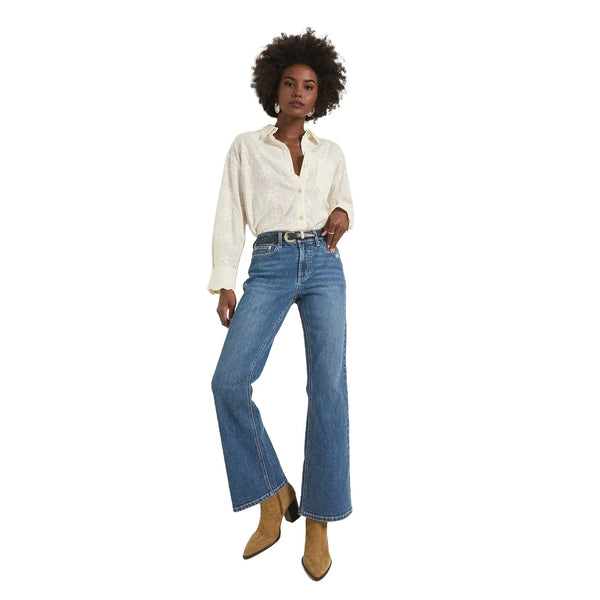 Close up view of the Button Down Eyelet Shirt showing intricate eyelet fabric details and delicate stitching against a soft white background.